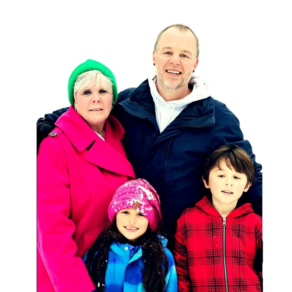 The Wilber family, smiling together outdoors in the snow.